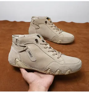 Detailed close-up of beige suede high-top boots featuring textured rubber soles and DBEC logo