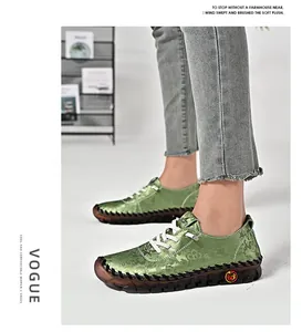 Detail of light green floral jacquard flat shoes with white laces and hand-stitched soles
