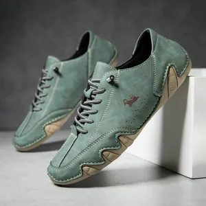 Detailed view of sage green suede casual shoes with crown logo and white stitching