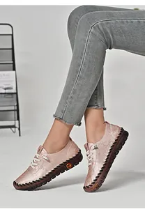 Close-up of pink casual flats with floral texture and durable rubber sole for women