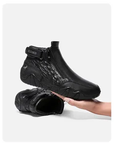 Close-up of black leather boot featuring crocodile texture and side zipper detail