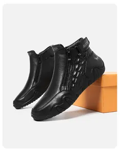 Detail of premium black leather boots with crocodile texture and metal side zipper