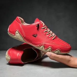 Detail of red leather casual shoes with black antelope logo and beige wavy soles