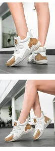 Détail de baskets compensées blanc et marron avec semelle ondulée et mélange de cuir premium