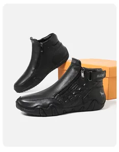 Detail of black leather boots with crocodile pattern, side zipper and horse logo