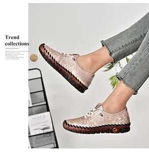 Close-up of women's vintage embossed leather flats with durable rubber soles and lace-up detail