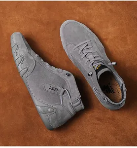 Detailed view of grey suede high-top shoe featuring wave-patterned non-slip sole