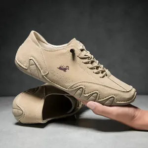 Close-up of flexible khaki suede loafer showing soft non-slip sole and side logo detail