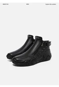 Detail of black leather high-top boots with embossed patterns and side metal zipper