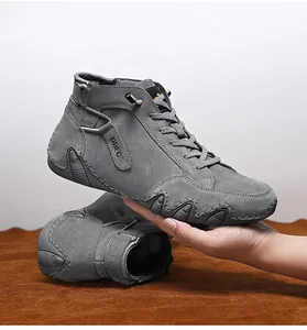 Close-up of grey leather high-top sneakers with non-slip sole and side logo detail