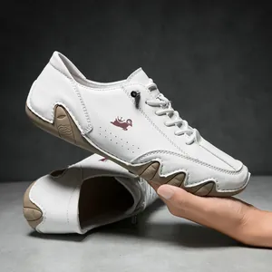 Detailed close-up of soft white leather casual shoe with stitching and crown logo