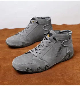 Macro view of grey high-top suede boots with DBEC logo and textured wavy sole