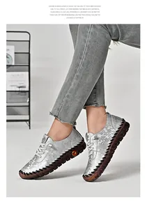 Close-up of floral embossed silver loafers with soft rubber sole and stitch details