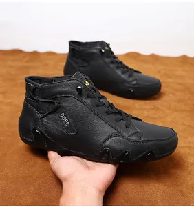 Close-up of grain leather texture and logo detail on black high-top men's boots