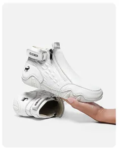 Detail of white embossed leather boots with zipper and Velcro strap for a secure fit