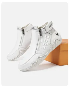 Detail of white high-top leather shoes featuring side zippers and embossed crocodile texture