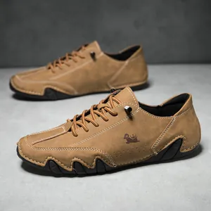 Close-up of brown suede men's casual shoes with white hand-stitched detail and non-slip rubber sole