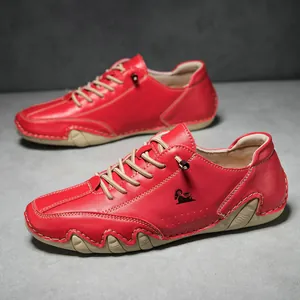 Detail of red leather casual men's sneakers with white stitching and textured sole