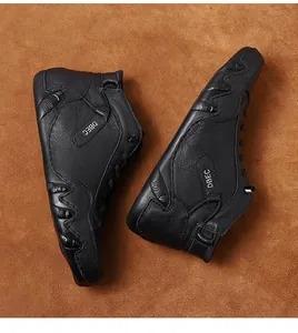Detailed top view of black leather high-top boots with pebble grain and rubber sole