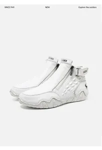 Detail view of white leather high-top boots with side zipper and crocodile texture accents