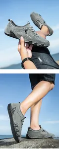 Detail of dark gray mesh and leather sneakers with wavy anti-slip rubber sole