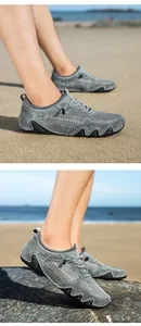 Detailed view of grey mesh breathable upper and embossed animal motif on men sneakers