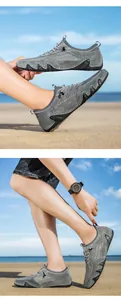 Detail of grey breathable mesh hiking shoe with rubber sole on a sunny beach scene