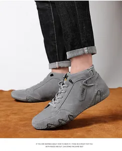Detailed side view of grey suede high-top sneakers with DBEC logo and wave-textured sole