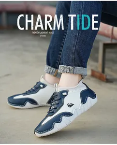 Detail of blue and white leather sneakers with unique stitching and wave-textured rubber sole