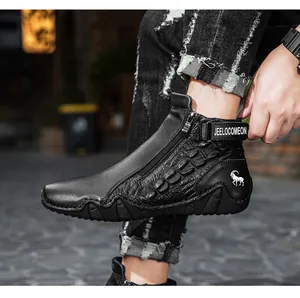 Detail of black leather high-top boots with crocodile texture and metal side zipper