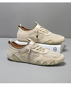 Detail of beige breathable mesh sneakers with leather panels and non-slip wavy sole