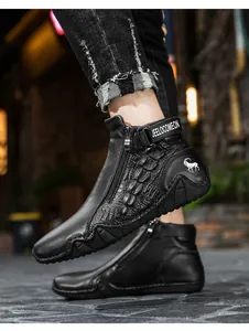 Detail of men's leather boots featuring crocodile pattern and side zipper closure
