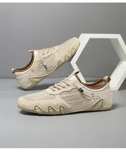 Detail of men's breathable beige mesh and suede casual sneakers with wavy sole design