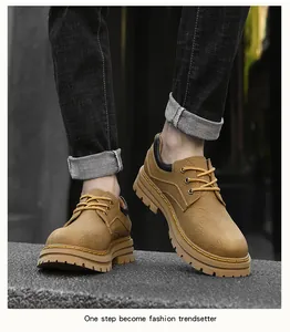 Top-down view of tan leather martin boots with yellow laces and rugged rubber soles