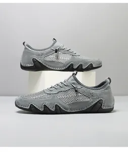 Macro detail of breathable grey mesh and leather sneakers with wavy rubber outsole