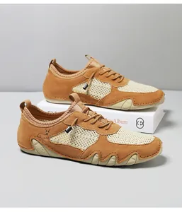 Detail of men's hiking shoe featuring brown suede panels and breathable mesh upper