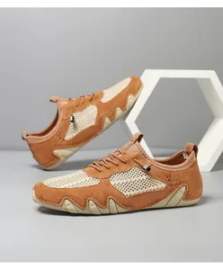 Detail of brown breathable mesh and suede upper with deer pattern on casual sports shoe