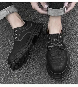 Detail of men's black leather shoes with contrast white stitching and rugged lug soles