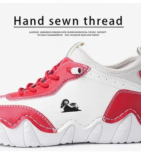 Detailed view of hand-sewn stitching and premium leather material on red and white casual shoe