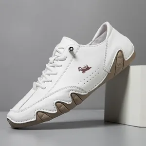 White leather casual shoes for men with wave-patterned rubber soles and goat logo