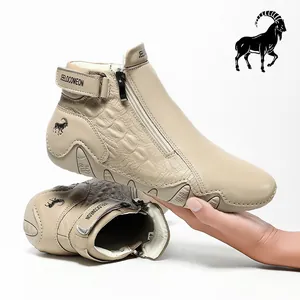 Detail of beige leather boot with crocodile texture embossing and side zipper closure