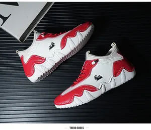 Detail of red and white leisure shoes featuring a unique wave-patterned thick sole