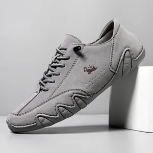 Grey suede men's casual low-top shoes with red logo and wavy non-slip rubber soles