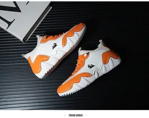 Detail showing wave-textured sole and orange contrast logo on white leather sneaker