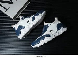 Close-up of white and blue casual sneakers with wavy sole and ram logo on black background
