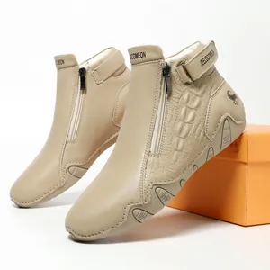 Men's khaki leather ankle boots with crocodile texture and side zipper on orange box