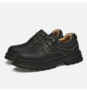 Detail of black leather lace-up boots with contrast white stitching and thick lug sole
