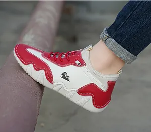Detail shot of red and white contrast sneakers with non-slip thick rubber soles