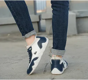 Detail of blue and white leather outdoor sneaker with ram logo and black laces