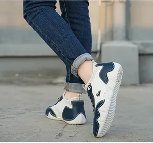 Detail view of children's blue and white patchwork sneakers with non-slip thick soles